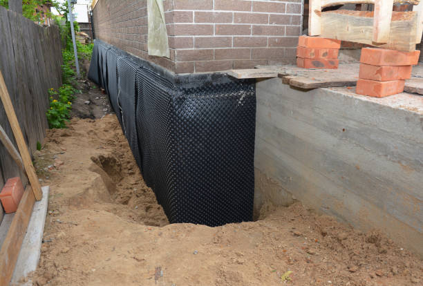 Happy homeowners after waterproofing job in Coloma